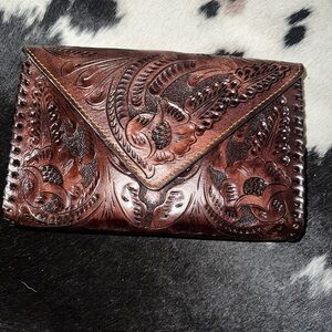 Hand-tooled leather Crossbody bag!
Elegant Embossed Brown Leather Clutch.